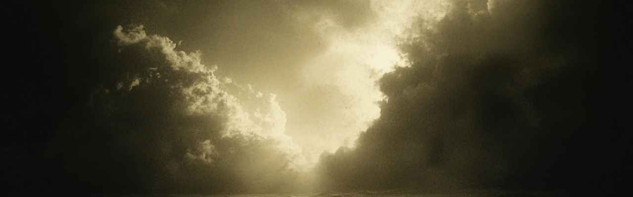 Expansive view of clouds parting to light, representing self-growth in how to be a high value man