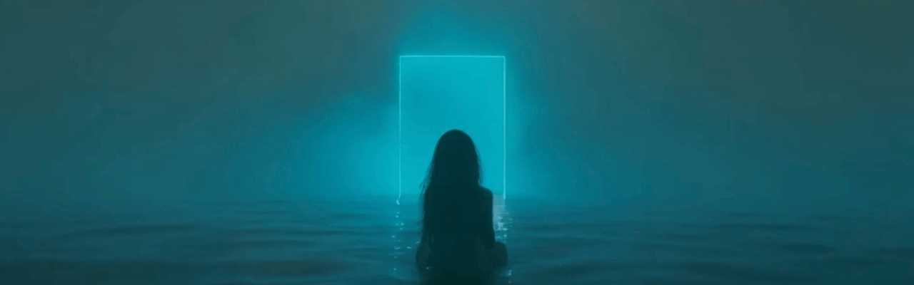 Woman alone in water looking toward light, capturing emotional depth and the weight of being available