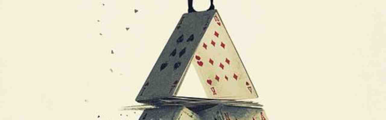 The Truth Of This Moment captured through a suspended house of cards, representing delicate balance and fragility.